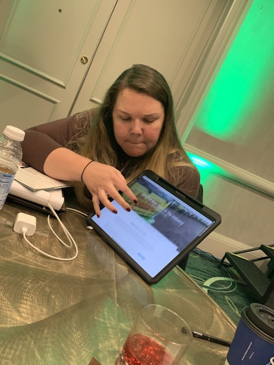 Angela Hieronimus showcases how her company Blades of Green utilizes text message and point system apps to communicate with and reward employees. Photo: Beth Presley/Total Landscape Care