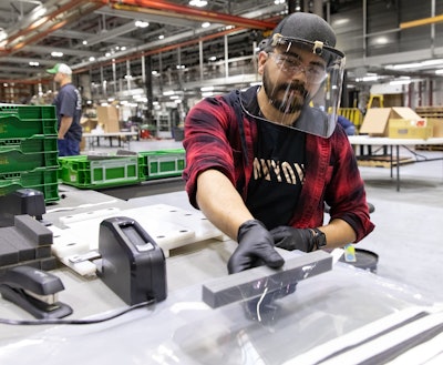 Jose Martinez assembles face shields. Photo: John Deere