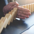 hand-blocking-domino-effect