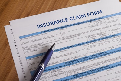 blank insurance claim form with pen on table