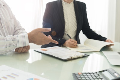 documents featuring data and analysis on a conference table during a business meeting