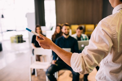 instructor holds pen while teaching a training session