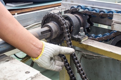 A dealership technician works on a piece of equipment.