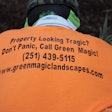 Landscaper wearing Green Magic Landscapes t-shirt
