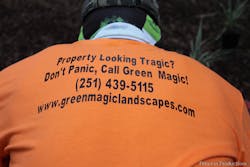 Landscaper wearing Green Magic Landscapes t-shirt
