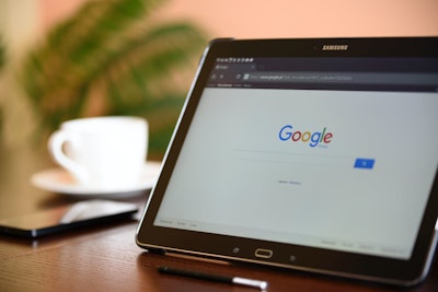 A Samsung tablet with Google pulled up sitting on a table.