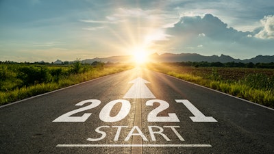 paved road facing the sun with '2021 start' stamped on the road