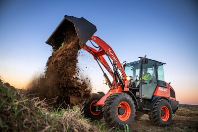 A Kubota R640 wheel loader dumping a bucket of dirt onto a pile