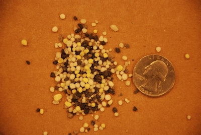 Black and white Bayer granular herbicide size comparison with a quarter