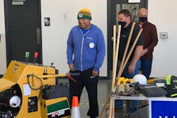 Edgar Contreras being presented with landscaping tools as part of Make-A-Wish Day at Vermeer Wisconsin
