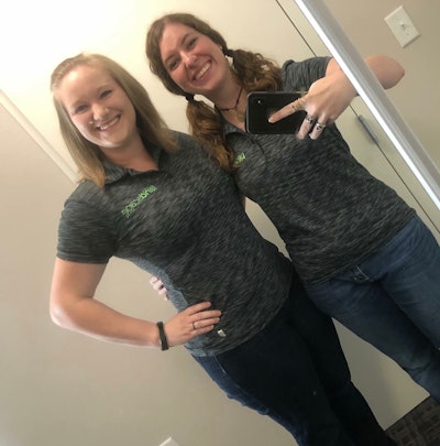 Beth Presley and Jill Odom wearing their Total Landscape Care shirts