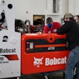 Diesel technicians working on a Bobcat A770 All-Wheel Steer indoors