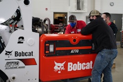 Diesel technicians working on a Bobcat A770 All-Wheel Steer indoors