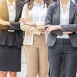 Four businesswomen standing with their arms crossed