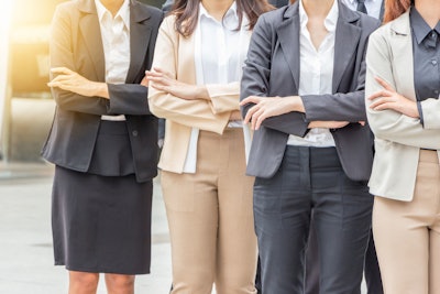 Four businesswomen standing with their arms crossed