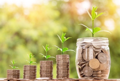 plants growing from coin stacks and a coin jar