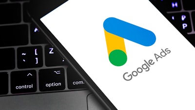 Google Ads logo on a smartphone that's sitting on top of a laptop keyboard