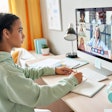 A student taking notes during a virtual meeting