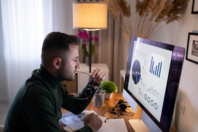 Man at desk looking at computer screen