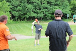3 men throwing a football together