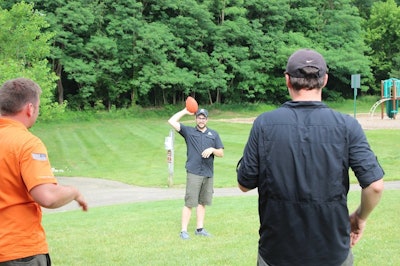 3 men throwing a football together