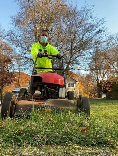 man operating lawn mower
