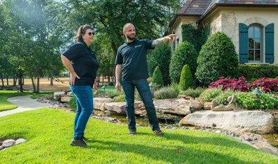 Landscaping professional speaking with client