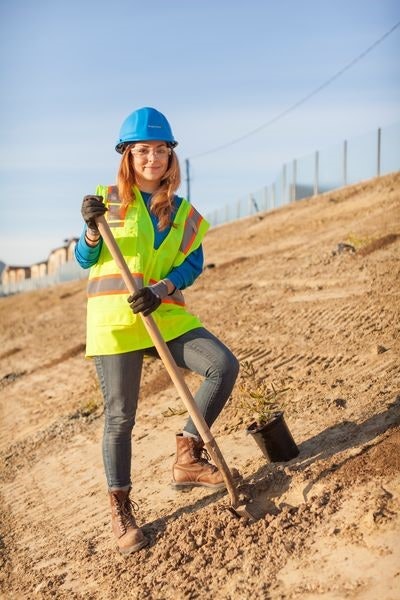 woman holding shovel on construction site