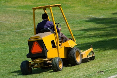 man operating landscaping equipment