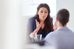 woman talking to man in workplace