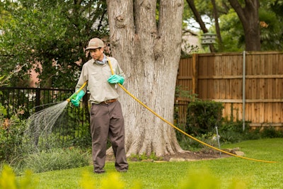 lawn technician spraying lawn