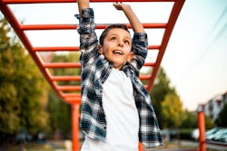kid playing on monkey bars