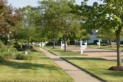 Community sidewalk lined with tress