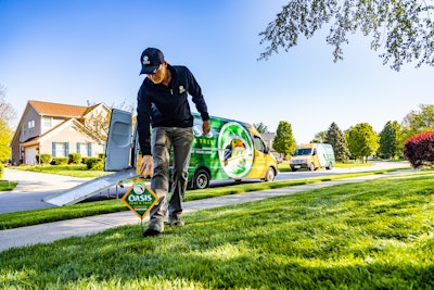 lawn care technician placing sign green lawn.jpg