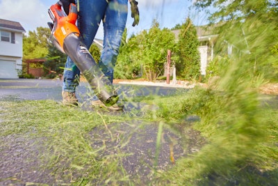 man operating cordless handheld blower