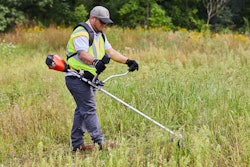 man operating brushcutter