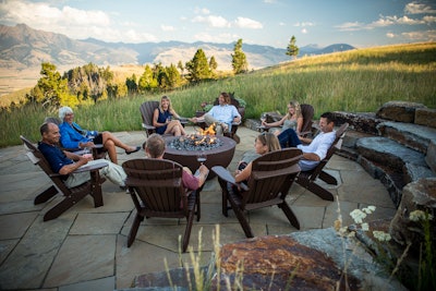 people sitting around a patio firepit