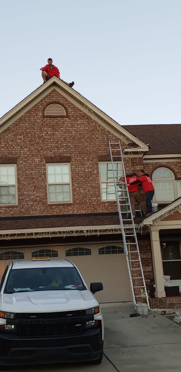aaron brazell and omega landscaping adding christmas lights to house