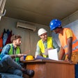 Construction management team discussing payroll.