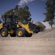 Cat wheel loader hauling load of gravel