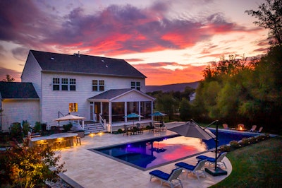 back porch of house with pool at sunset