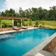 pool with a pergola and chairs