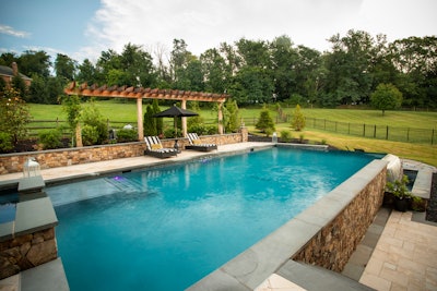 pool with a pergola and chairs