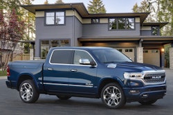 2023 Ram 1500 Limited Elite blue parked in front of house