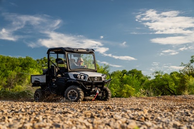 2023 Kubota Sidekick UTV stone gray limited edition on gravel trees in background