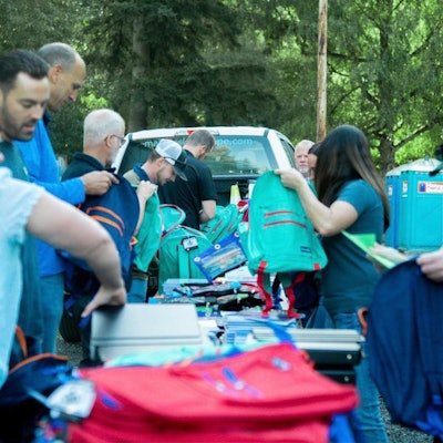 Industry Collective members packing backpacks
