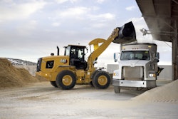 Cat 926 wheel loader dumping bucket into truck