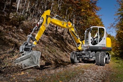 EW100 Wacker excavator digging on trail