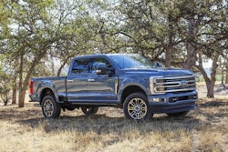 2023 Ford Super Duty F350 Limited bluish gray side view oak trees in background
