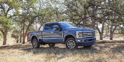 2023 Ford Super Duty F350 Limited bluish gray side view oak trees in background